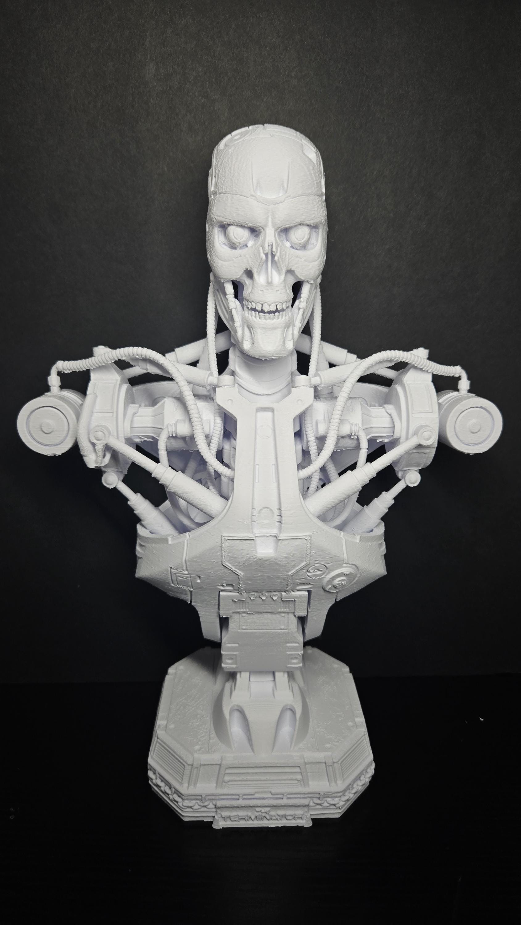 Large 3D printed grey T-800 Endoskeleton bust on a matching display stand