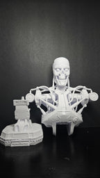An 11-inch tall 3D printed T-800 cyborg bust standing on a desk to show its large physical scale