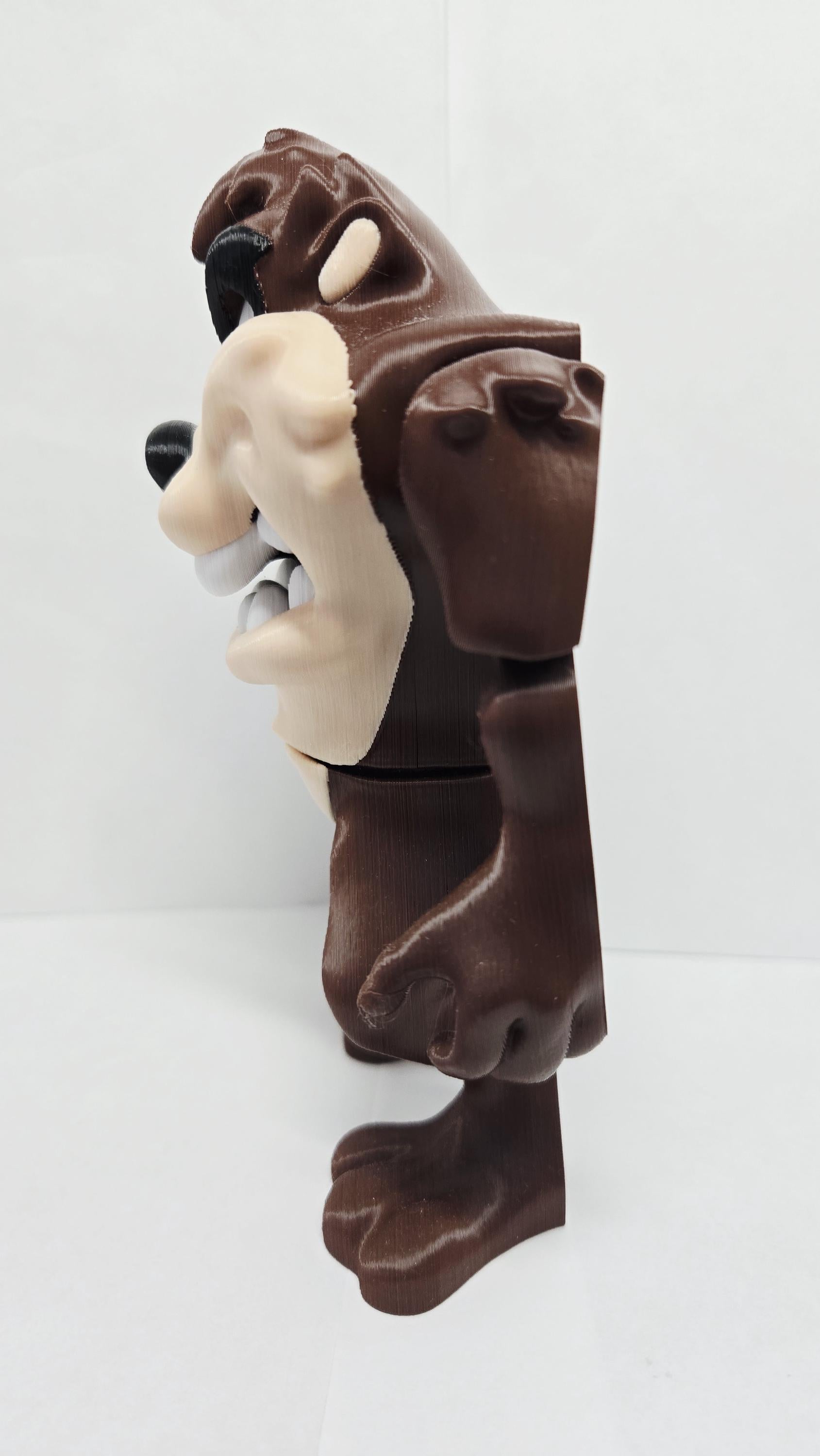 Left side profile view of the flexible Taz figurine demonstrating its multi-layered color texture and arm joints