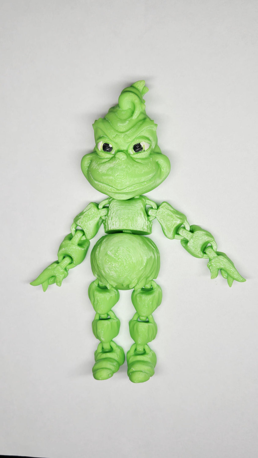 Full-length view of the 3D printed grumpy holiday star flexi figure showing his articulation and character design