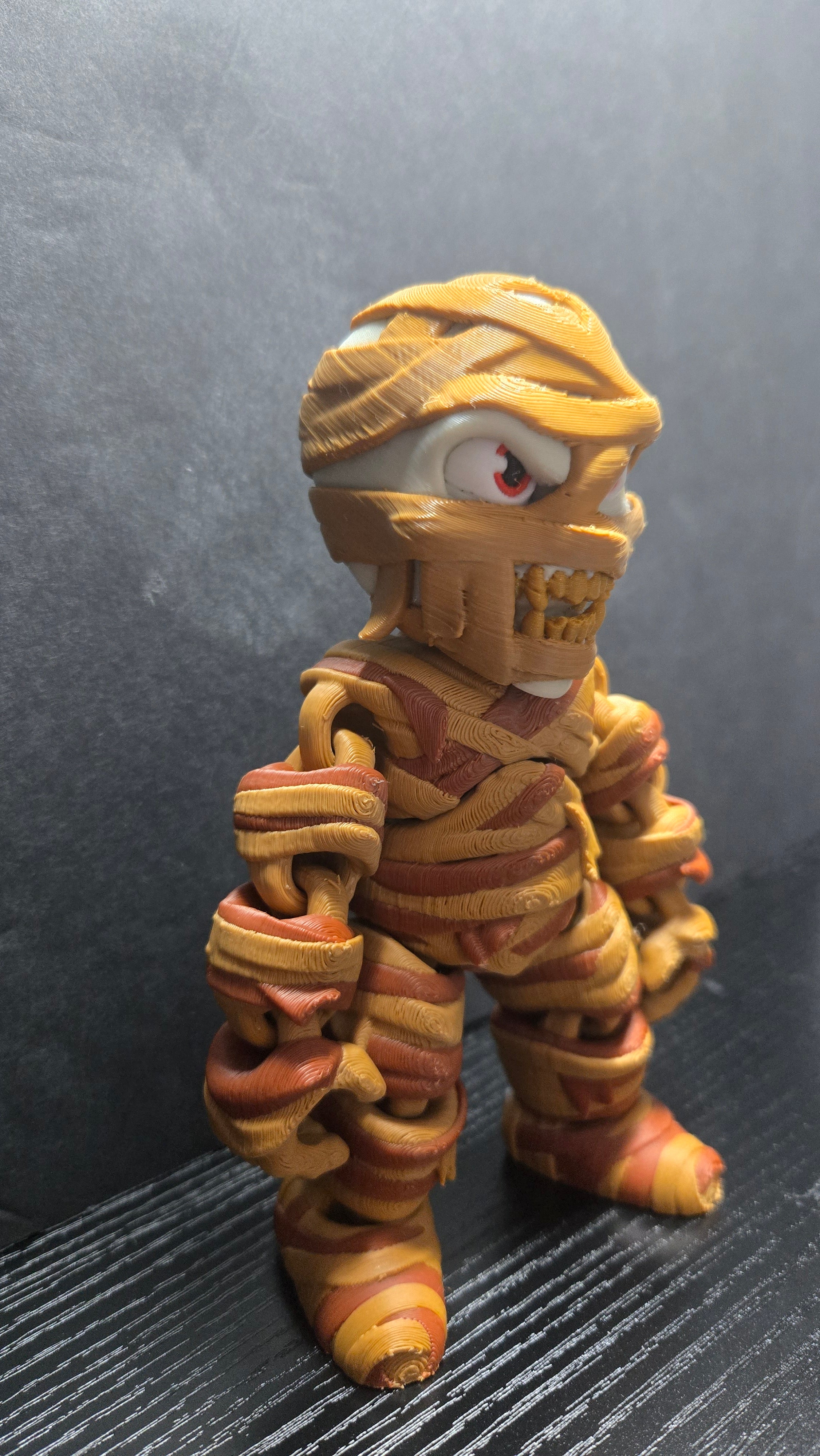 Right side profile view of the Mummy flexi figure highlighting its head wrap and articulated arm joints