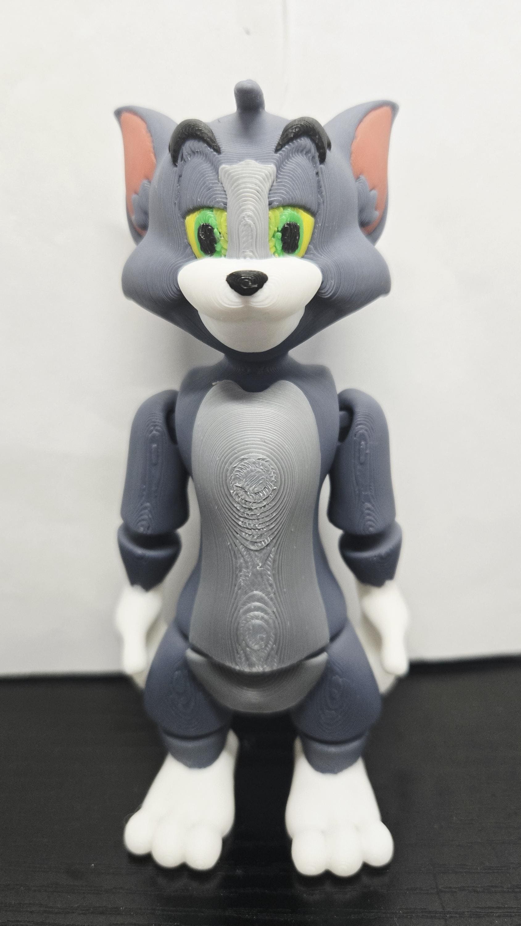Straight front view of the jointed Tom Cat figure to demonstrate the multi-color face and chest print details