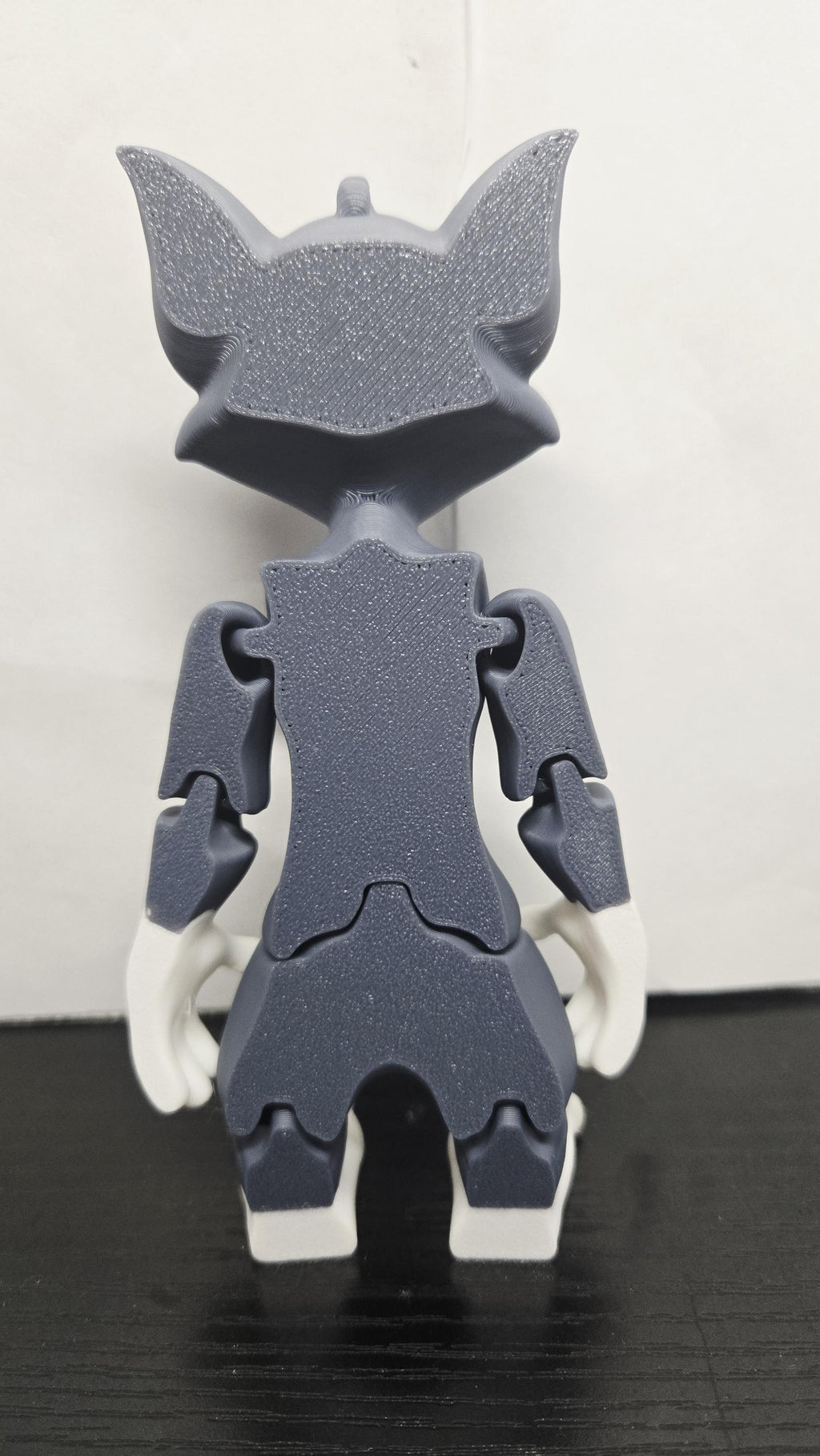 Rear view of the 3D printed Tom Cat figurine showcasing the clean jointed interlocking segments and articulated back limbs