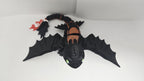 Side view of the flexible Toothless figure in a dynamic pose to showcase body movement