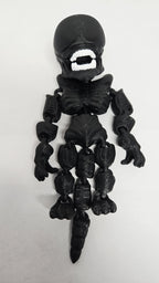 Straight front view of the articulated black Xenomorph flexi figure showing the detailed head shape and jointed limbs