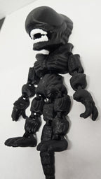 Right side view of the jointed Xenomorph figure slightly flexed to demonstrate the dynamic movement of the tail and leg segments